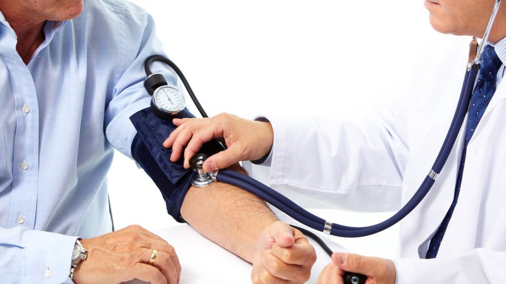 Doctor measuring a patient's blood pressure with a sphygmomanometer.